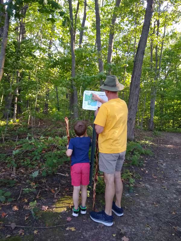 Man and child looking at trail map sign at Kraemer Lake-Wildwood Park